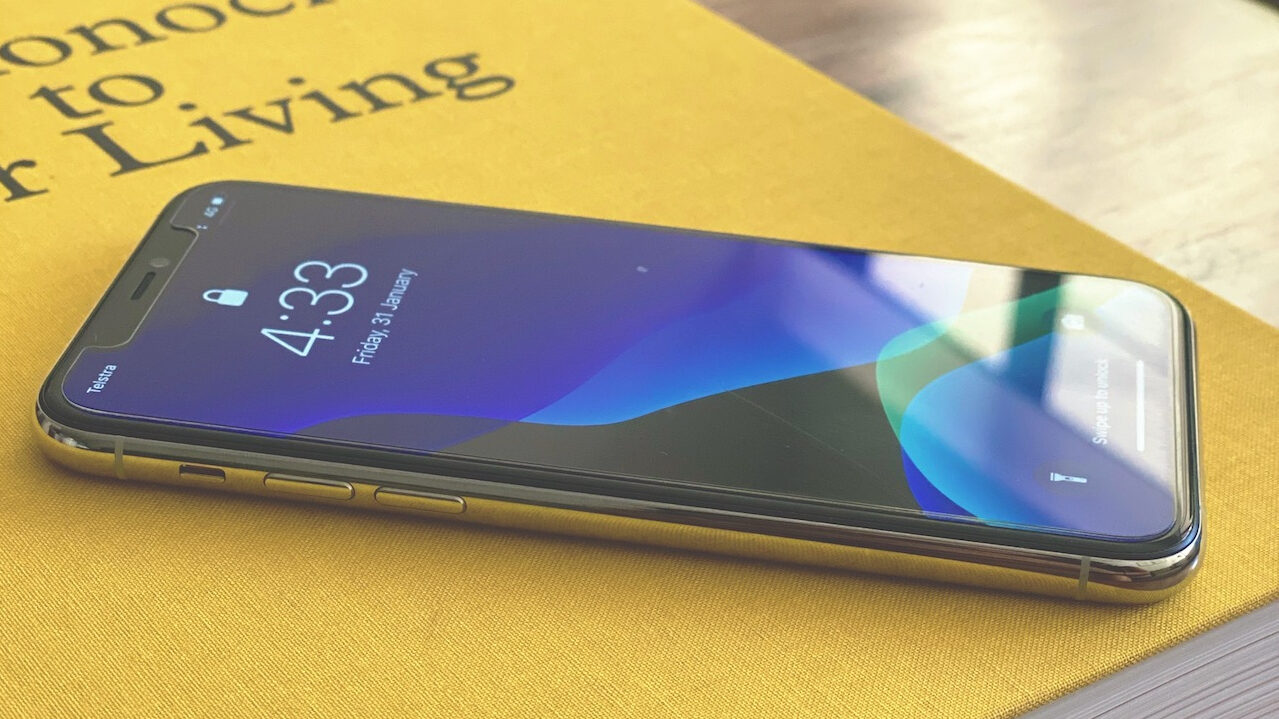 iPhone 11 Pro sitting on top of a yellow book