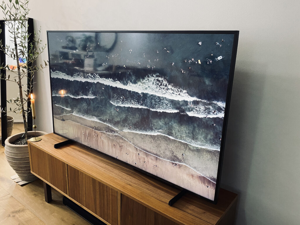 65-inch Samsung Frame TV 2021 model on a brown wood entertainment unit