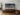 65-inch Samsung Frame TV 2021 model on a brown wood entertainment unit in Art Mode
