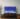 65-inch Samsung Frame TV 2021 model on a brown wood entertainment unit displaying the Home Screen