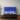 65-inch Samsung Frame TV 2021 model on a brown wood entertainment unit displaying the Home Screen