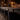 Hickson House long bar with alcohol and lights with high-backed bar chairs