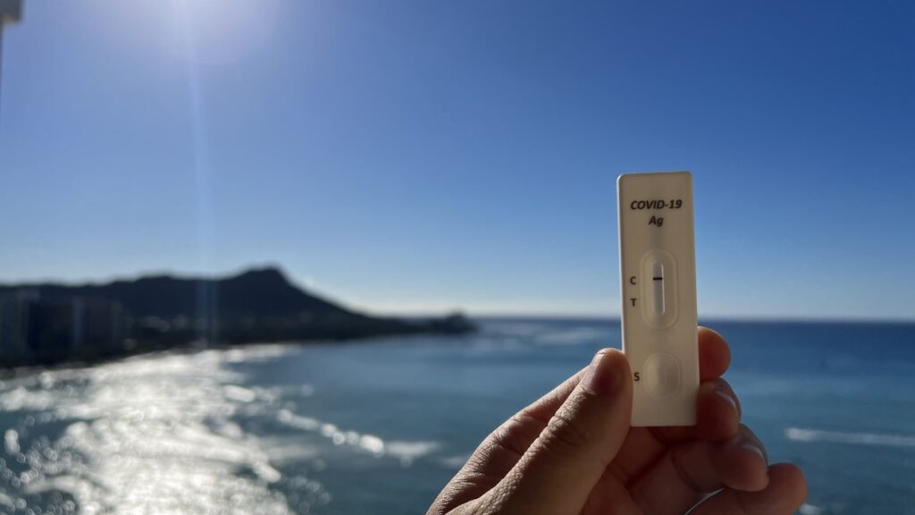 A negative Rapid Antigen COVID-19 test in front of Diamond Head crater in Waikiki