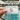 An American Express Platinum card in front of a pool at a luxury hotel