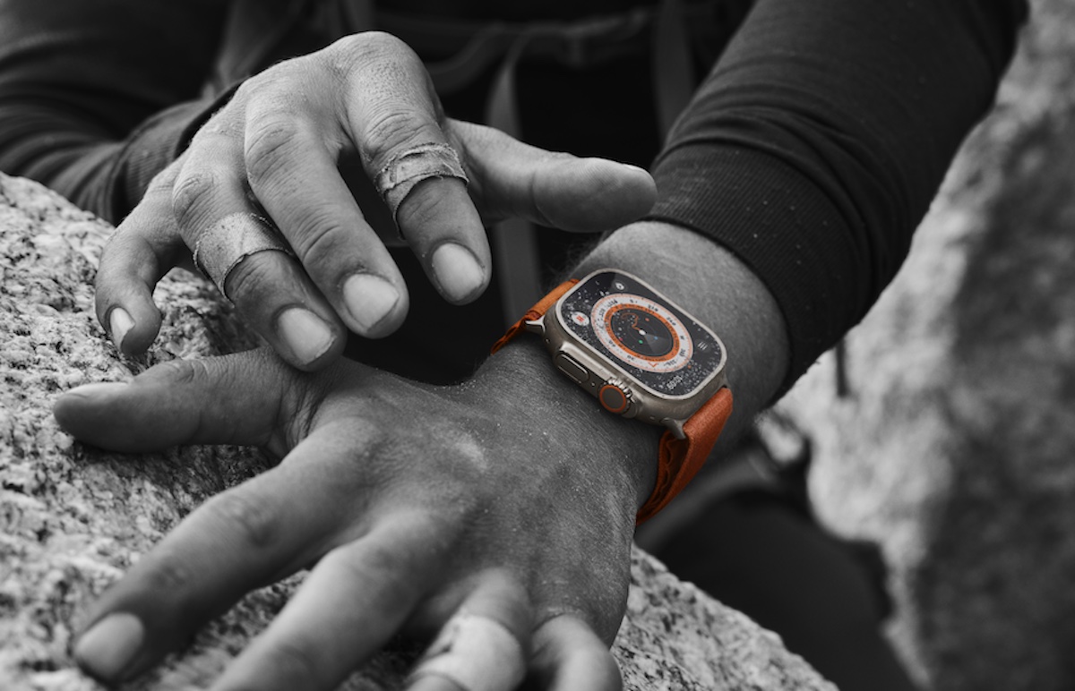Apple Watch Ultra on a man's wrist near a rock