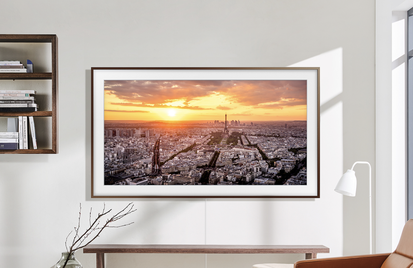 Samsung The Frame TV 2023 model hanging on a white wall with a sunset cityscape on the screen
