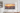 Samsung The Frame TV 2023 model hanging on a white wall with a sunset cityscape on the screen