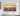 Samsung The Frame TV 2023 model hanging on a white wall with a sunset cityscape on the screen